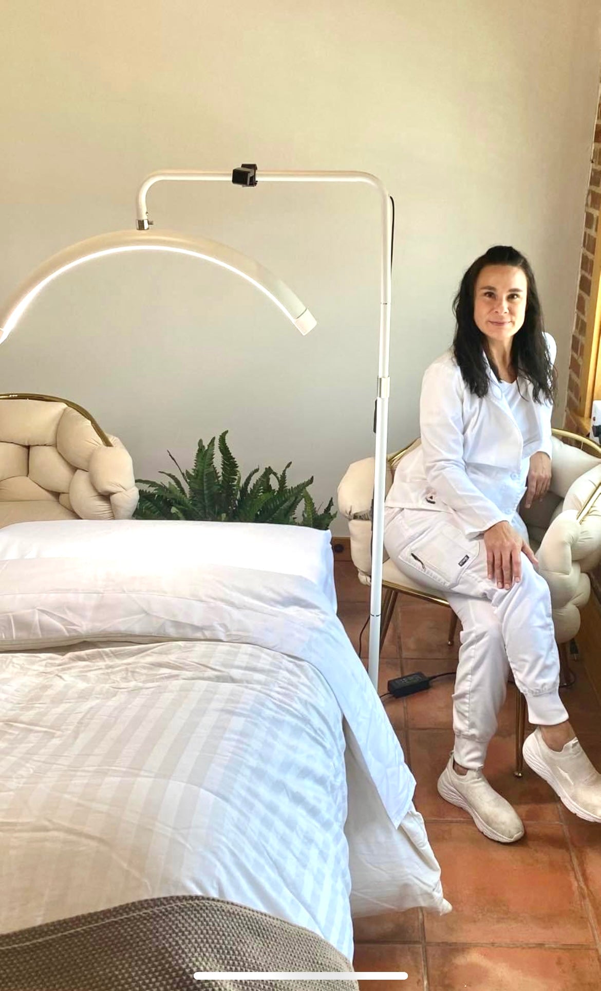 Chasity beside the treatment bed at Blue Moon Elise